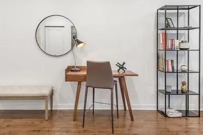 a desk with a chair and a mirror in a room at Modern 2BR - 2 Full Bathrooms - Trendy Griffintown in Montréal