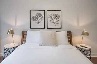 a bedroom with three pictures on the wall above a bed at Modern 2BR - 2 Full Bathrooms - Trendy Griffintown in Montréal