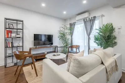 a living room with a couch and a tv at Modern 2BR - 2 Full Bathrooms - Trendy Location in Montréal