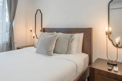 a bedroom with a large white bed with pillows at Modern 2BR - 2 Full Bathrooms - Trendy Location in Montréal