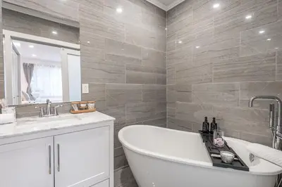 a bathroom with a tub and a sink at Modern 2BR - 2 Full Bathrooms - Trendy Location in Montréal