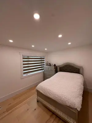 a bedroom with a bed and a window at Maison prestige sur la rive in Laval