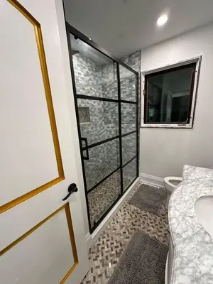 a bathroom with a shower with a toilet and a window at Maison prestige sur la rive in Laval