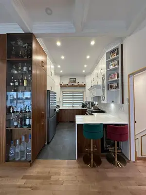 a kitchen with a counter and a refrigerator at Maison prestige sur la rive in Laval