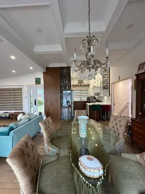 a living room with a glass table and chairs at Maison prestige sur la rive in Laval