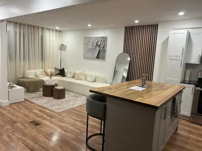 a kitchen and a living room with a couch at luxury townhouse in Montreal in Longueuil