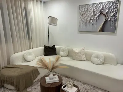 a living room with a white couch with pillows at luxury townhouse in Montreal in Longueuil