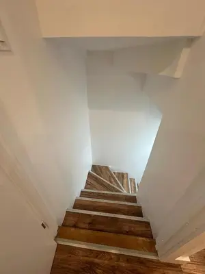 a staircase in a house with wooden floors at luxury townhouse in Montreal in Longueuil