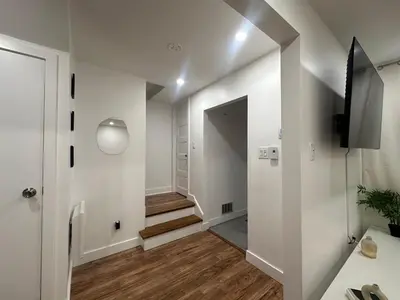 a hallway with white walls and a stairway at luxury townhouse in Montreal in Longueuil