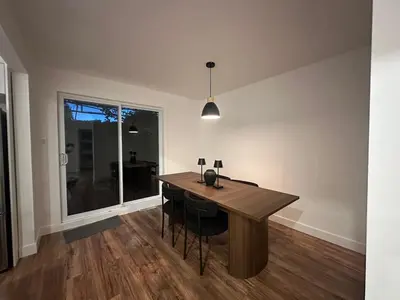 a dining room with a wooden table and chairs at luxury townhouse in Montreal in Longueuil