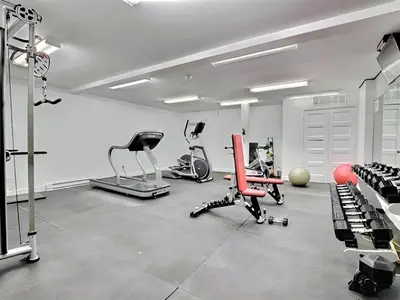 a gym with several exercise equipment in a room at Urban Serenity NDG in Montréal