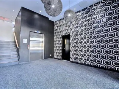 a lobby with a hallway with a door and a wall at Urban Serenity NDG in Montréal