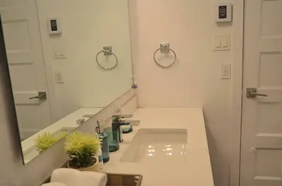 a bathroom with a sink and a mirror at Urban Serenity NDG in Montréal