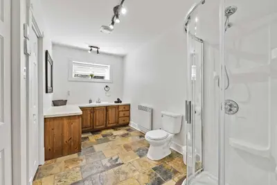 a bathroom with a toilet and a sink and a shower at Lake - Spa - Pool Table - Chalet Ookpik in Potton