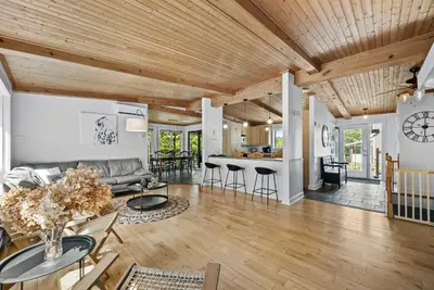 a living room with a couch and a table at Lake - Spa - Pool Table - Chalet Ookpik in Potton