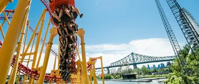 a roller coaster with a bridge in the background at Downtown Private Room & Workspace Metros Sherbrooke & Berri! Fast Wifi! in Montréal