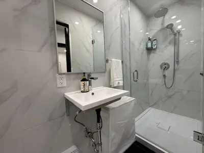 a white bathroom with a sink and a shower at Downtown Private Room & Workspace Metros Sherbrooke & Berri! Fast Wifi! in Montréal