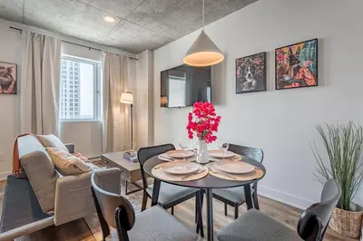 a living room with a table and chairs at Skyline Suite - Modern 1 BR in Montréal