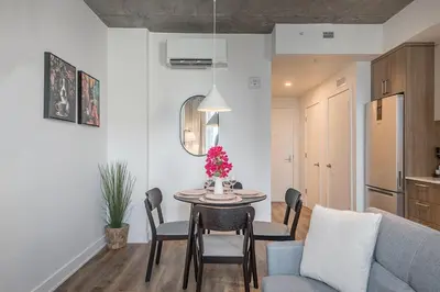a living room with a table and a couch at Skyline Suite - Modern 1 BR in Montréal