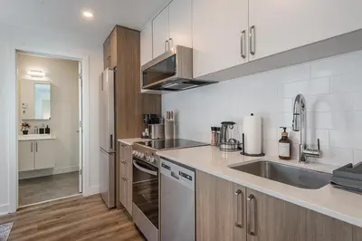 a kitchen with a sink and a counter top at Cozy Corner - Modern 1BR in MTL in Montréal