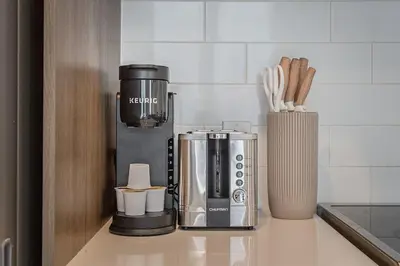 a coffee maker on a counter in a kitchen at Cozy Corner - Modern 1BR in MTL in Montréal