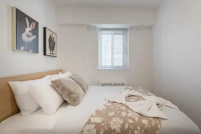 a bedroom with a bed with white sheets and pillows at The Nest - Comfy 1 bedroom in Prime Location in Montréal