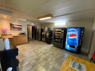 a room with a soda vending machine in a restaurant at Motel St-Eustache in Saint-Eustache