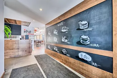 a restaurant with a wall with stickers on it at Motel St-Eustache in Saint-Eustache