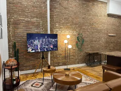 a living room with a tv on a brick wall at Top Location - The 777 Old Port Gem in Montréal