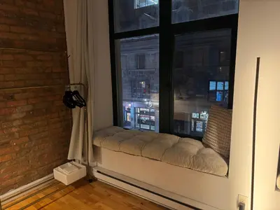a window seat in a room with a view of a city at Top Location - The 777 Old Port Gem in Montréal