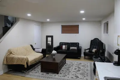a living room with a couch and a table at Perfect location brand new basement 1 bedroom full basement with kitchen in unit laundry separated in Laval