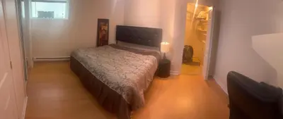 a bedroom with a bed in a small room at Perfect location brand new basement 1 bedroom full basement with kitchen in unit laundry separated in Laval
