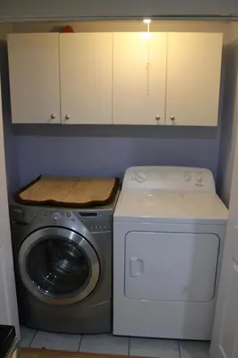a kitchen with a washing machine and a washer at Perfect location brand new basement 1 bedroom full basement with kitchen in unit laundry separated in Laval