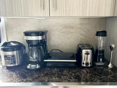 a kitchen counter with a coffee maker and a blender at Big Luxury 2 Bedroom Condo, Free Parking, Near Downtown, King size Bed in Longueuil