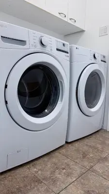a white washer and dryer sitting next to each other at Big Luxury 2 Bedroom Condo, Free Parking, Near Downtown, King size Bed in Longueuil