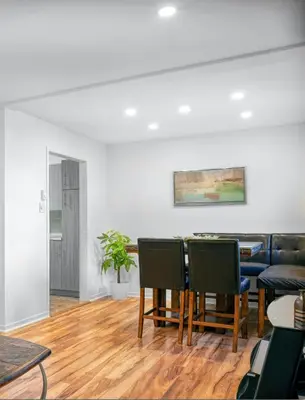 a living room with a table and chairs at Big Luxury 2 Bedroom Condo, Free Parking, Near Downtown, King size Bed in Longueuil