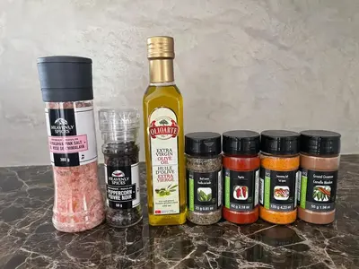 a group of spices next to a bottle of sauce at Big Luxury 2 Bedroom Condo, Free Parking, Near Downtown, King size Bed in Longueuil