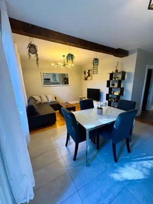 a living room with a table and chairs and a couch at La Pause Montréal in Montréal