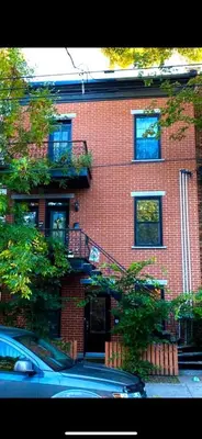 a red brick building with a staircase in front of it at La Pause Montréal in Montréal