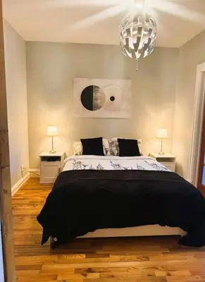 a bedroom with a large bed and two lamps at La Pause Montréal in Montréal