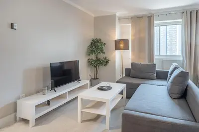 a living room with a couch and a tv at Cozy 1BR - Heart of Montreal in Montréal