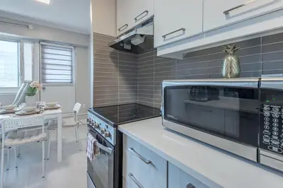 a kitchen with a counter with a microwave and a stove at Cozy 1BR - Heart of Montreal in Montréal