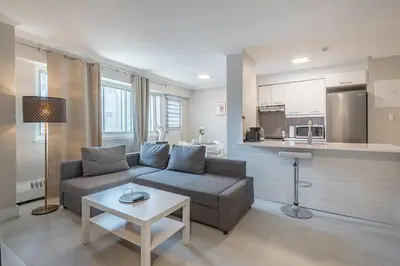 a living room with a couch and a table at Cozy 1BR - Heart of Montreal in Montréal