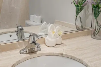 a bathroom counter with a sink and a mirror at Outstanding 1BR in Heart of Downtown Montreal in Montréal