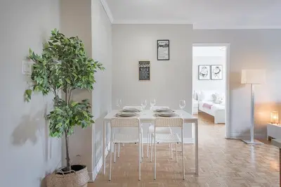 a white dining room with a table and chairs at Outstanding 1BR in Heart of Downtown Montreal in Montréal