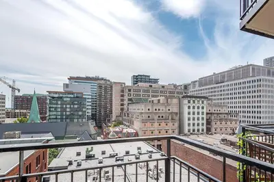 a view of a city from a balcony at Outstanding 1BR in Heart of Downtown Montreal in Montréal