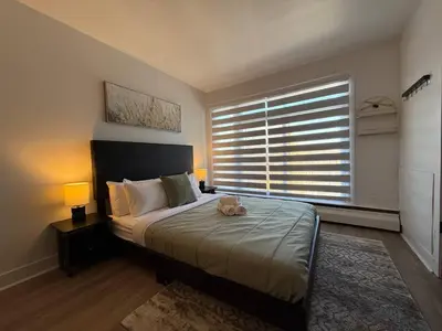 a bedroom with a bed with a cat laying on it at McGill Les Petits Studios, Downtown & Nightlife in Montréal