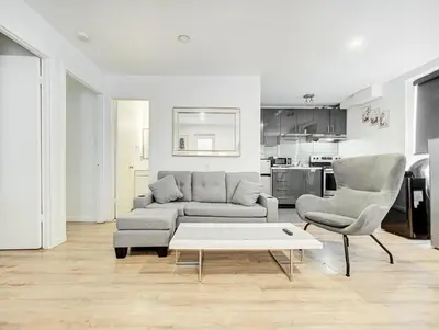 a living room with a couch and two chairs and a table at Charmant 2BD in Montréal