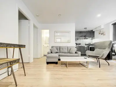 a living room with a couch and two chairs and a table at Charmant 2BD in Montréal