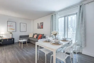 a living room with a table and a couch at Spacious and Cozy 1BR - Near Old Port in Montréal
